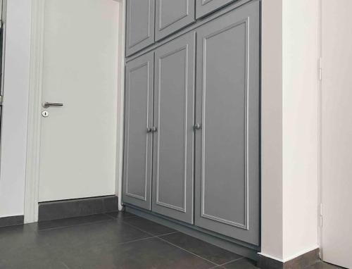 a room with gray cabinets and a tile floor at City Center Studio Apartment in Heraklio
