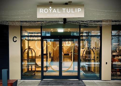 a store front with a revolving door to a restaurant at Royal Tulip Warsaw Centre in Warsaw