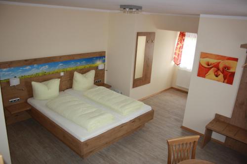 a bedroom with a large bed in a room at Landgasthof Haagen in Schwabhausen bei Dachau