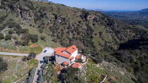 an aerial view of a house on a mountain at Geroulios Kastro, a Grand Estate, By ThinkVilla in Vatoudhiáris