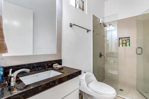 a bathroom with a toilet and a sink and a shower at Casa Violeta 42 - Playa Arcangel in Rosarito