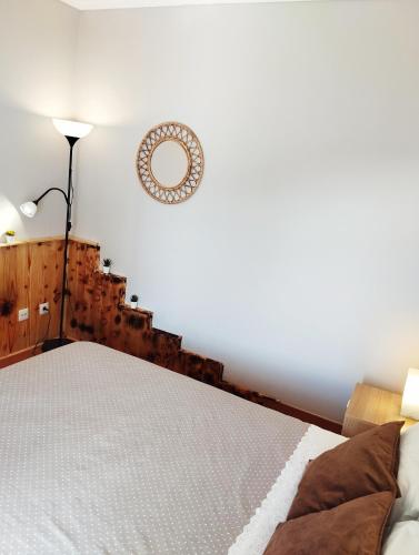a bedroom with a bed and a mirror on the wall at Casa Vale do Paraíso in Sesimbra