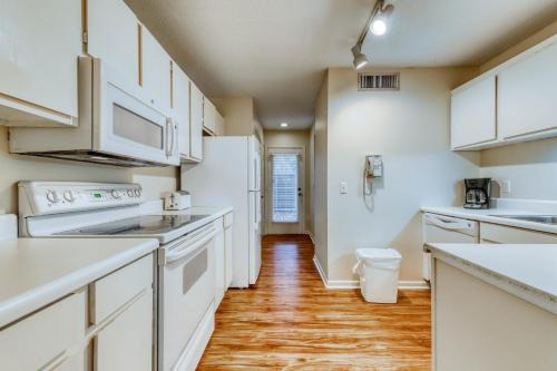 a kitchen with white appliances and a wooden floor at Heritage Villas 2307 in Hilton Head Island