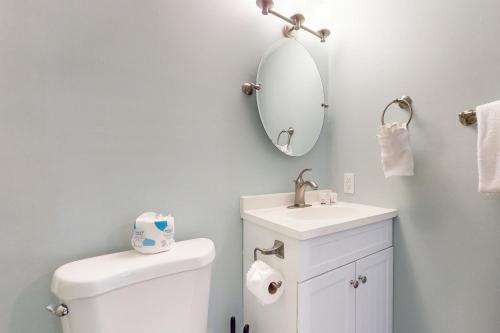 a bathroom with a toilet and a sink and a mirror at Rehoboth Beach -- The Crest #303 in Rehoboth Beach