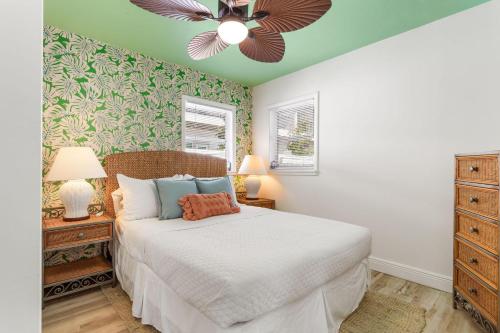 a bedroom with a bed and a ceiling fan at Pink Flamingo in Dunedin