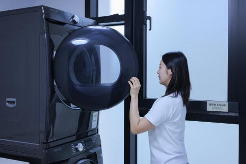 a young woman is lifting a wheel on a television at From H Heritage Hotel in Mokpo