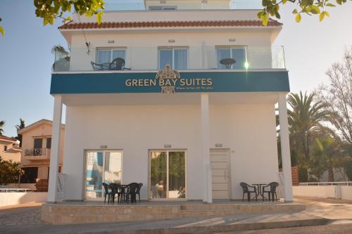 a white building with a green bay suites sign on it at Green Bay Suites in Protaras