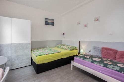 a bedroom with two beds and a table at Villa Dora ##3 in Crikvenica