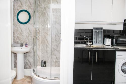 a bathroom with a shower and a sink at Duke's Den - Liverpool City in Liverpool