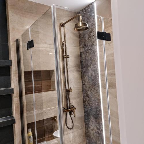 a shower with a glass door in a bathroom at Apartament Bulwary317 in Oświęcim