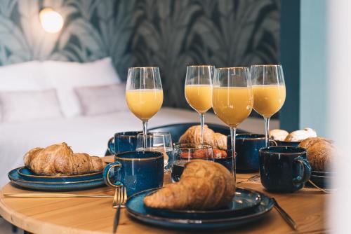 a table with two glasses of orange juice and croissants at LVM Stays in The Hague