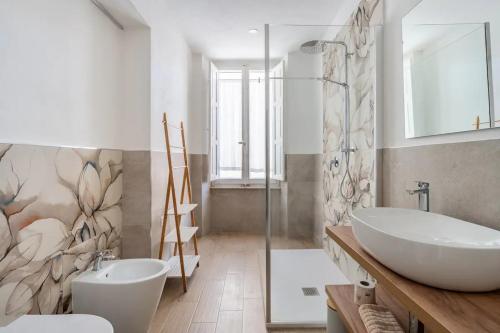 a bathroom with a white tub and a sink at B&B Affittacamere Via del Centro in La Maddalena