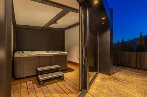 a room with a bed on a deck at Zerm Holiday House with pool, jacuzzi & sauna - Gorski kotar in Mrkopalj