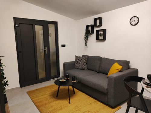 a living room with a gray couch and a table at Apartment Boras in Vir