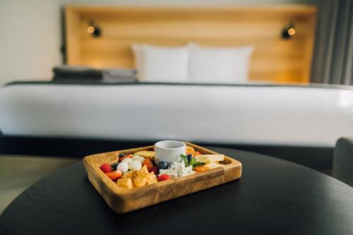 a tray of food on a table in a hotel room at OTTO Hotel & Sun in Pāvilosta