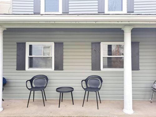 three chairs and a table in front of a house at Luxe On Walnut/King Bed/Off St.Parkin/30 days stay in Lancaster