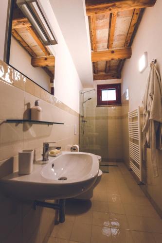 a bathroom with a sink and a glass shower at Villa Montefiore Country Resort in Borghetto