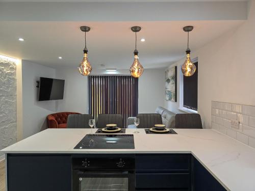 a kitchen with a counter and a living room at DYSA Bond Apartments in Blackpool