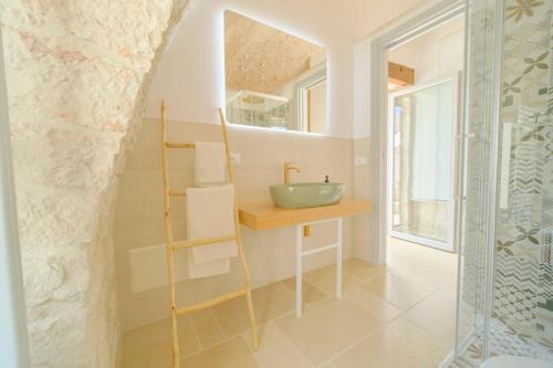 a bathroom with a sink and a mirror at Palazzo Gentile in Locorotondo