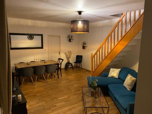 un salon avec un canapé bleu et une table dans l'établissement Villa bodié, à Troyes