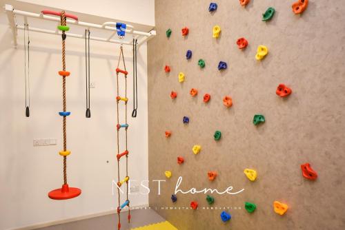 a wall with a bunch of climbing equipment on it at Sunway Grid Loft Suite by Nest Home【Olympic Size Pool】 in Kampong Pendas