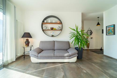 uma sala de estar com um sofá e um espelho em Ka' Doro with Lake View em Nesso