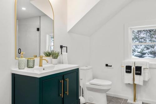 a bathroom with a sink and a toilet and a window at Hudson Valley and The Berkshires Cottage in Hillsdale