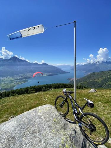 a bike parked on top of a rock with a sign at Hotel Europa - Sorico in Sorico