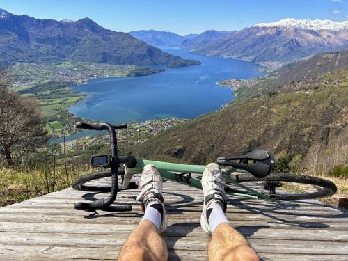 a man is laying on a bike on a wooden path at Hotel Europa - Sorico in Sorico