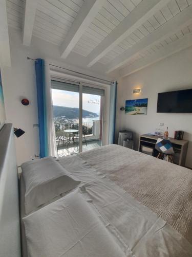 a bedroom with a large bed and a large window at The Stunning B&B in Peschici