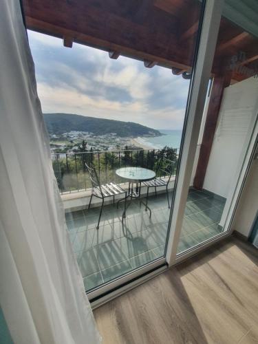 a balcony with a table and a view of the ocean at The Stunning B&B in Peschici