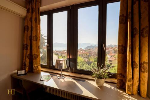 a window with a desk with a view of a city at Hotel Italia in Lerici