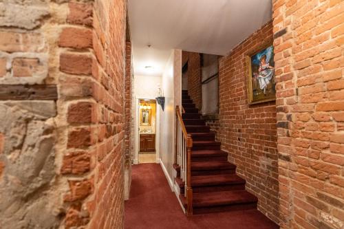 a brick hallway with stairs and a brick wall at Quarter House Suites in New Orleans