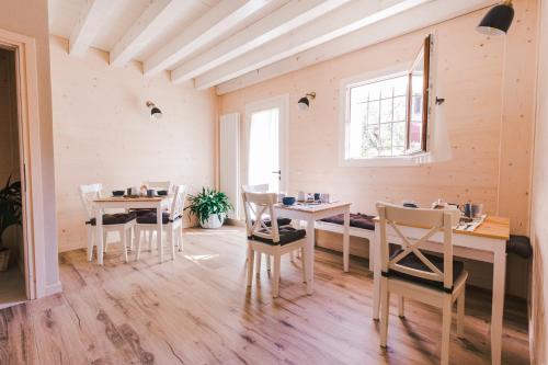 a dining room with tables and chairs and a window at b&b al fienile in Paderno del Grappa
