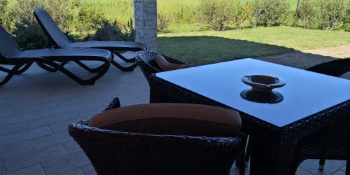 a table and chairs sitting on a patio at Agrialbergo Capalbio La Sugherella in Capalbio
