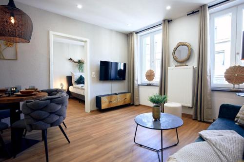 a living room with a couch and a table at LIVING Apartments / FeWo Neuwied in Neuwied