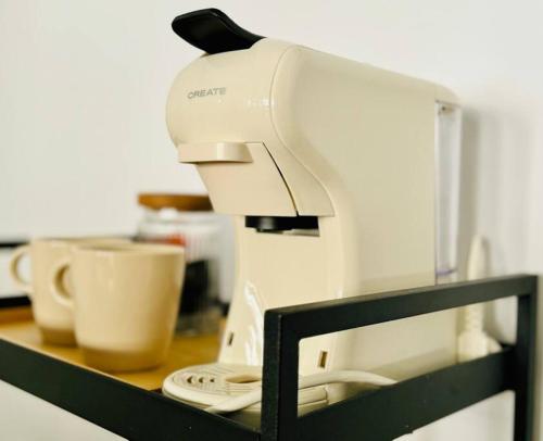 a white sewing machine sitting on top of a counter at Chic & Stylish Madrid Hideout in Madrid