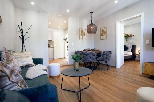 a living room with a couch and a table at LIVING Apartments / FeWo Neuwied in Neuwied
