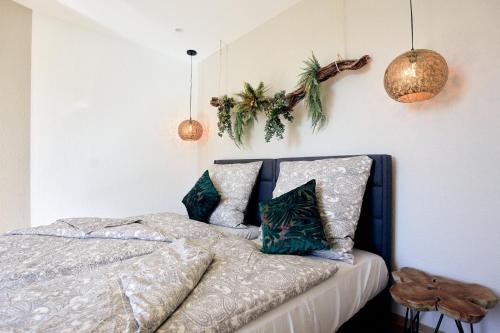 a bedroom with a bed with plants on the wall at LIVING Apartments / FeWo Neuwied in Neuwied