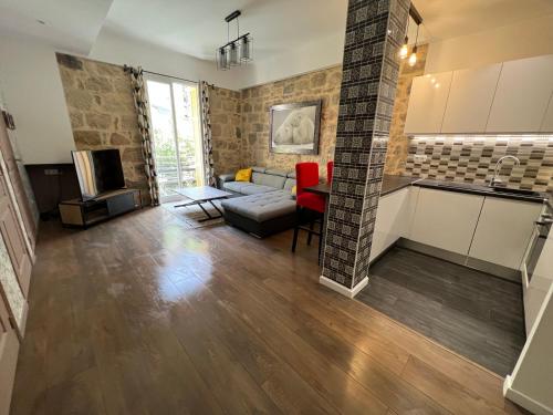 une cuisine et un salon avec un canapé et une table dans l'établissement Belle perle rare port de Nice, à Nice