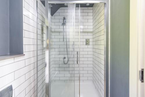 a shower with a glass door in a bathroom at Decoy Farm House in Somerton
