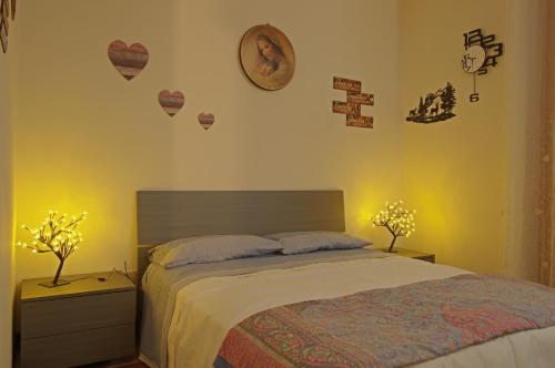 a bedroom with a bed with two night stands and two lamps at Gianni's beautiful house in the mountains in Lama Di Peligni