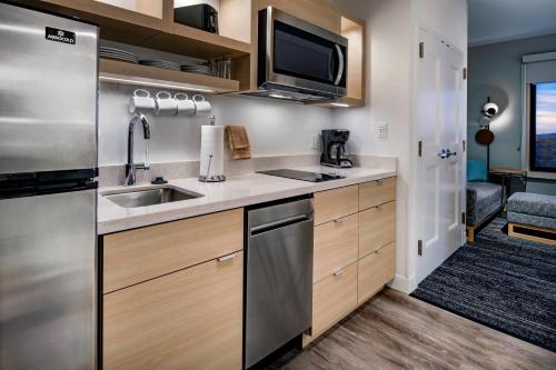 a kitchen with a sink and a microwave at TownePlace Suites By Marriott Wrentham Plainville in Wrentham