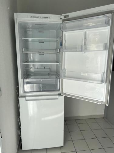 an empty refrigerator with its door open in a kitchen at Nice Riviera in Nice