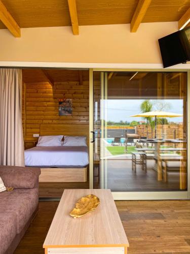a bedroom with a bed and a patio with a table at Villas turísticas del noroeste in Villanueva de Arosa