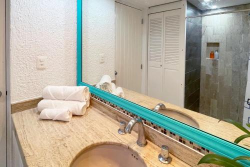a bathroom with a sink and a mirror at Seaside Escape Studio in Cancun Beach in Cancún