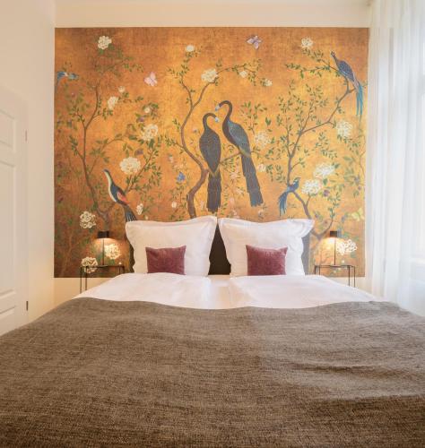a bedroom with a large bed with a floral wall at Boardinghouse Luise 5 in Heidelberg