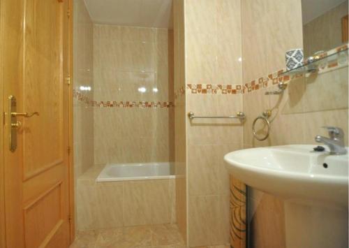 a bathroom with a sink and a shower with a tub at RNET-Nautilus Roses Costa Brava in Roses