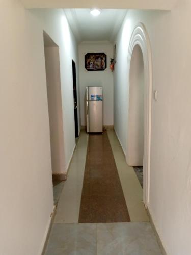 a hallway with a refrigerator in a room at Cossy Luxury Hotel and Apartments in Galadima