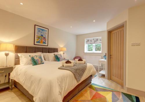 a bedroom with a large bed and a window at Wensum Retreat 